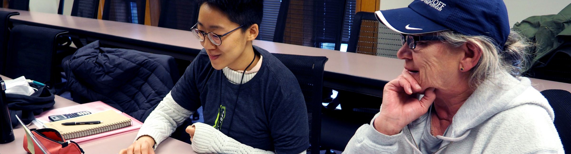 Two people working at laptop computer